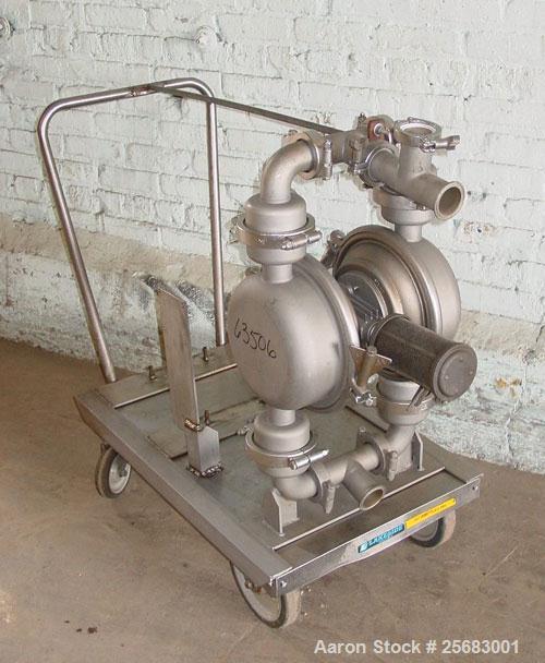 Used- Diaphragm Pump, Air Operataed, stainless steel. 2" tri-clamp inlet/outlet. Mounted on a stainless steel cart with cast...