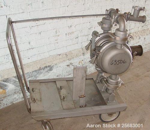 Used Diaphragm Pump, Air Operataed, stainless steel. 2" tri-clamp inlet/outlet. Mounted on a stainless steel cart with casters.