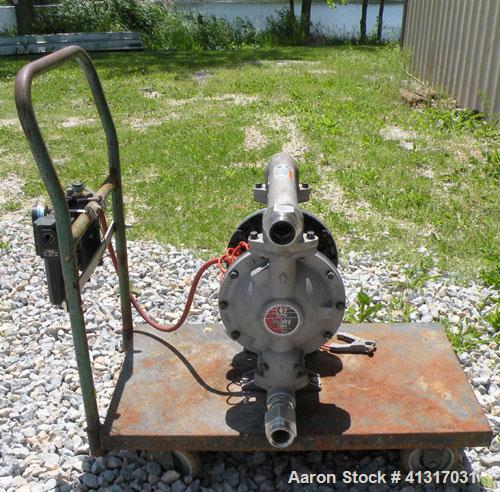 Used Husky Air Operated Double Diaphragm Pump, Series E98A, 316 Stainless Steel. 2" NPT inlet/outlet.  Rated maximum 100 gallons per minute, 120 psi.  Mounted on a carbon steel cart with casters.