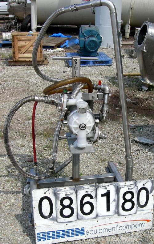 USED: Wilden air operated double diaphragm pump, model M2CHAMP, plastic. Rated 27 gallons per minute, 125 psi. 1-1/2" flange inlet, 1" NPT outlet. Mounted on a stainless steel frame with casters.
