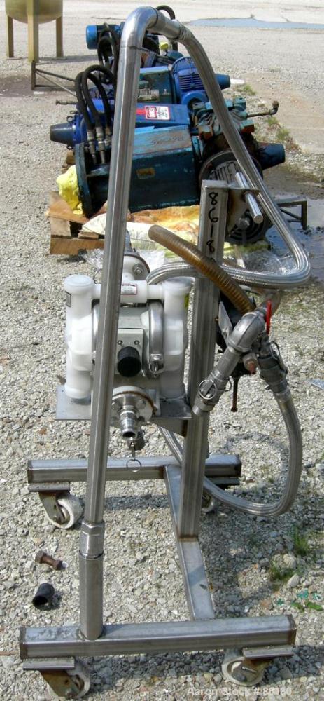 USED: Wilden air operated double diaphragm pump, model M2CHAMP, plastic. Rated 27 gallons per minute, 125 psi. 1-1/2" flange inlet, 1" NPT outlet. Mounted on a stainless steel frame with casters.
