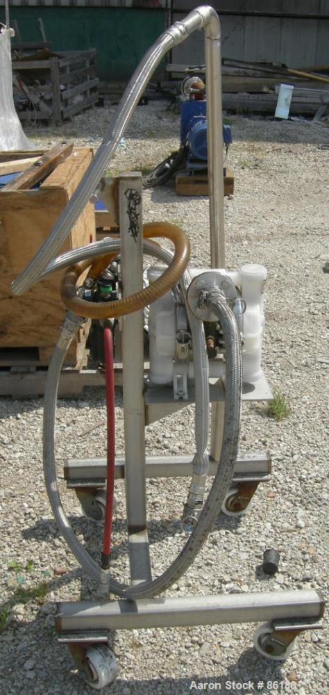 USED: Wilden air operated double diaphragm pump, model M2CHAMP, plastic. Rated 27 gallons per minute, 125 psi. 1-1/2" flange inlet, 1" NPT outlet. Mounted on a stainless steel frame with casters.