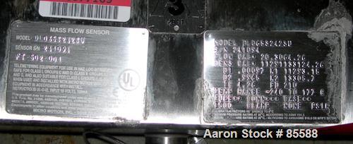 USED: Micro Motion flow meter, model DL065S242SU, 316 stainless steel product contact areas. Flow cal 20.3064.26, dens flow 11291133124.26. Rated volume 0 to 15 gallons per minute, mass 0 to 125 poun...