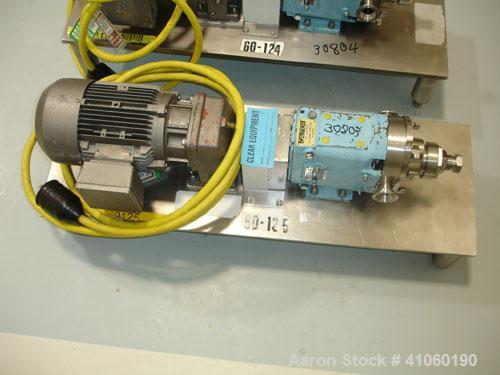 Used Waukesha Rotary Lobe Pump, Model 006. Stainless steel construction, 1.5" inlet/outlet, rated approximately 5 gpm on base with 1.5 hp 230/460 volt motor, serial #122569.