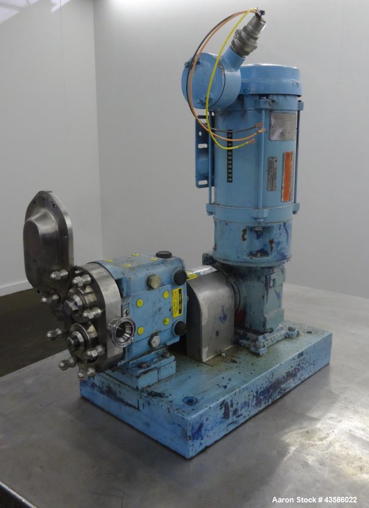 Used Waukesha Positive Displacement Pump, Model 015U2AP, 316 Stainless Steel. 1-1/2" Tri-clamp inlet/outlet, (2) stainless steel rotors. Driven  by a 1-1/2 hp, 3/60/230/460 volt, 1740 rpm XP gear mot...