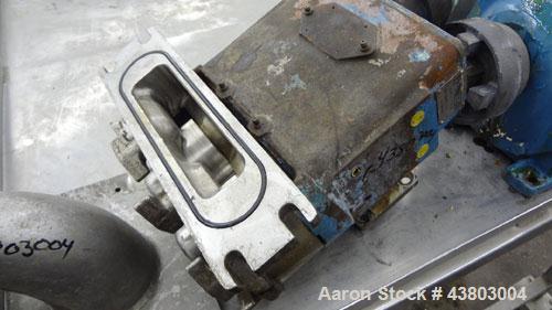 Used Waukesha Rectangular Flange Universal Rotary Positive Displacement Pump, Model 034, 316 Stainless Steel. Approximately 24 gallons per minute at 200 psi at 400 rpm, (0.060) gallon displacement pe...