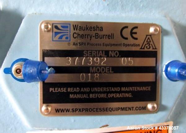 Used Waukesha Rotary Lobe Pump, Model 018, Stainless Steel. 1.5" Inlet/outlet, rated up to 20 gpm, on base with 1 hp, 230/460 volt motor drive, serial# 377392 05.