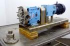 Used Waukesha Universal Rotary Positive Displacement Pump, Model 060, 316 Stainless Steel. Approximately 90 gallons per minute at 200 psi at 600 rpm. (0.153) gallons displacement per revolution. 2-1/...