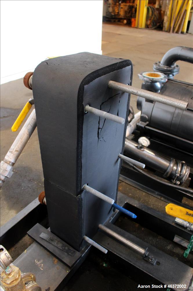 Used Travaini Vacuum System, Model TRW1000H-FR, Carbon Steel. Consisting of Travaini vacuum pump, model TRHE100-1600/X-C/F, serial #AN214-FDPKG, approximately 1000 CFM, 4" inlet/outlet, driven by 100...