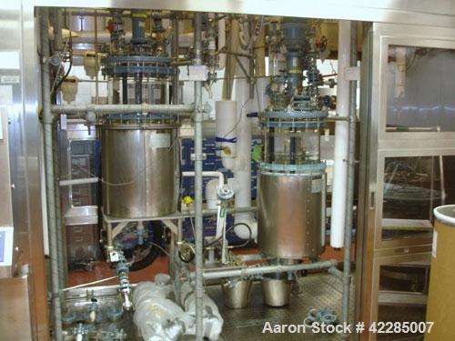 Used Buchi Reactor Train consisting of: (1) Buchi 100 Liter Glass Reactor, (1) Buchi 100 Liter Glass Agitated Receiver, (2) Vertical Glass Coil Condensers, (1) Vertical Coil Vent Condenser. 