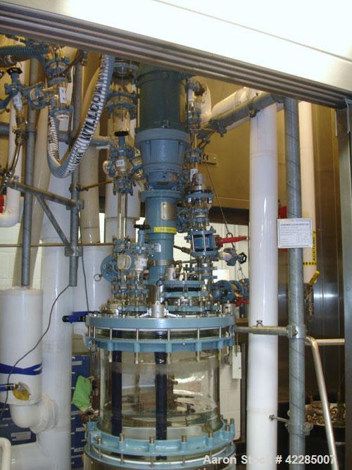 Used Buchi Reactor Train consisting of: (1) Buchi 100 Liter Glass Reactor, (1) Buchi 100 Liter Glass Agitated Receiver, (2) Vertical Glass Coil Condensers, (1) Vertical Coil Vent Condenser. 
