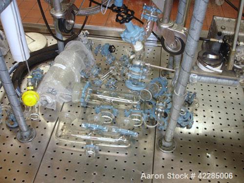 Used Buchi Reactor Train consisting of: (1) Buchi 70 liter glass reactor, removable dish top, dish bottom. Internal rated -1/+0.5 bar (-14.5/7.2 psig) +200/-50 deg C, jacket rated 10 bar (145 psig) a...