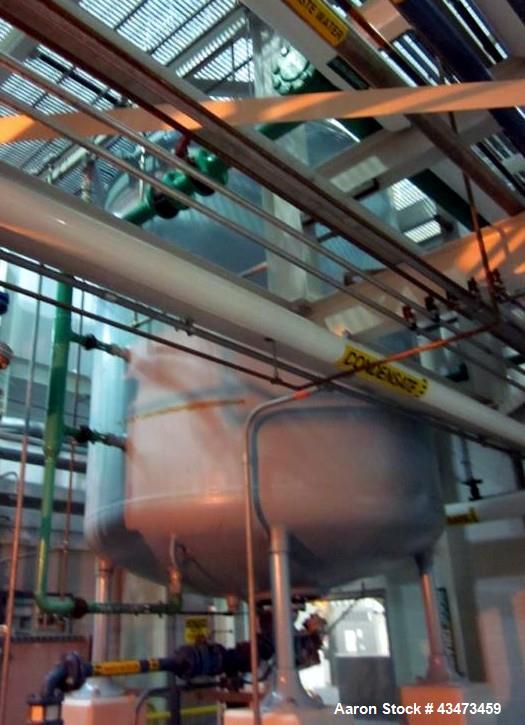 Used Pfaudler glass lined reactor, 2,000 gallon, rated full vacuum/100 psi @ 450 degrees F internal, jacketed for 90 psi @ 450 degrees F, with 3 blade retreat curve agitator, serial# J046932, built 2...