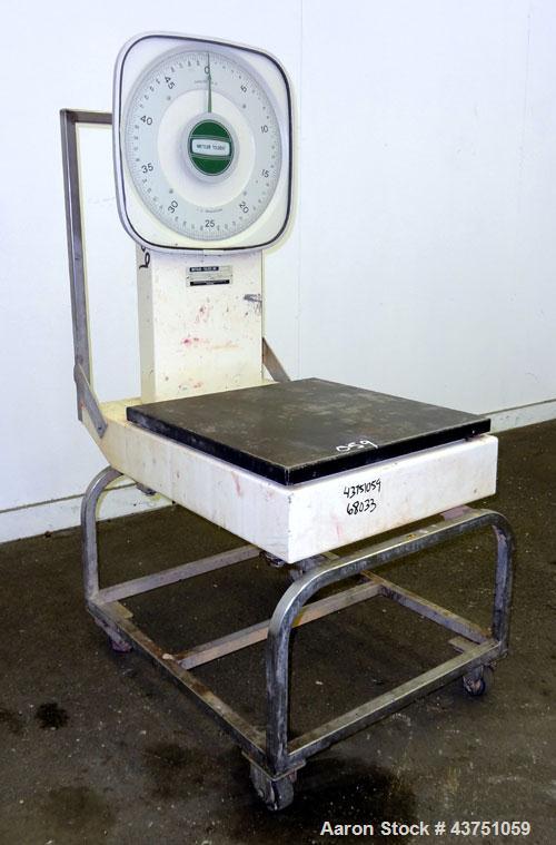 Used Mettler Toledo Mechanical Dial Scale, Model 2020. 50 Pound capacity. 19" x 20" Stainless steel platform. Mounted on a frame with casters.