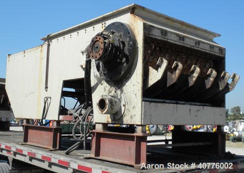 Used Holzmag Single Roll Shredder. Material of construction is carbon steel. 23.4” (600 mm) diameter x 66” (1690 mm) straight side roll with interchangeable knives. Hydraulic ram. Screen with 1.17” x...