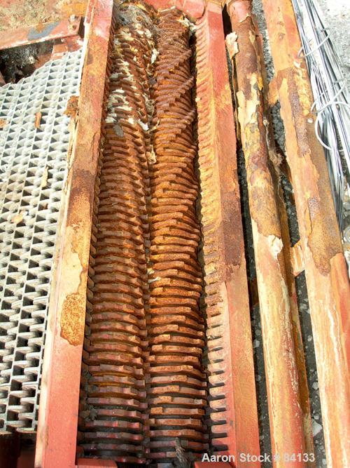 USED: JWC Environmental twin shaft open Channel Muffin Monster shredder, model 30003-40. Carbon steel. (2) rows of 4" diameter x 40" wide x 1/4" thick intermeshing cutters. Rated approximately 2000 g...