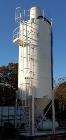 Used Belgrade Steel Tank 550 BBL Silo. 2,200 Cubic Feet Capacity. Carbon Steel. Side ladder. Cone bottom. Mounted on 4 legs. Air Lock on discharge with approximate 3/4 hp motor. Top mounted dust coll...