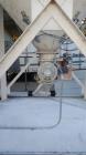 Used Belgrade Steel Tank 550 BBL Silo. 2,200 Cubic Feet Capacity. Carbon Steel. Side ladder. Cone bottom. Mounted on 4 legs. Air Lock on discharge with approximate 3/4 hp motor. Top mounted dust coll...