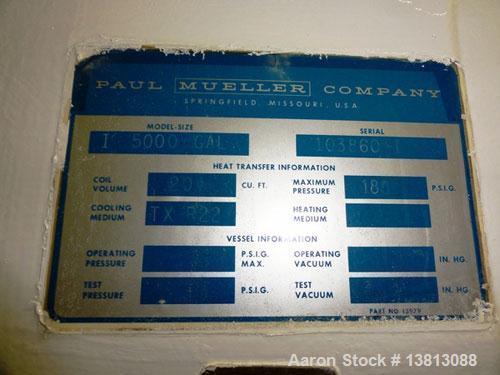 Used Mueller 5,000 Gallon Top Agitated Tank, R-22 cooling coils, mild steel exterior shell, dish top and dish bottom, bottom side manway, (8) mild steel legs, 2" bottom center tri-clamp discharge, 9'...