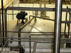 Used Mueller 5,000 Gallon Top Agitated Tank, R-22 cooling coils, mild steel exterior shell, dish top and dish bottom, bottom side manway, (8) mild steel legs, 2