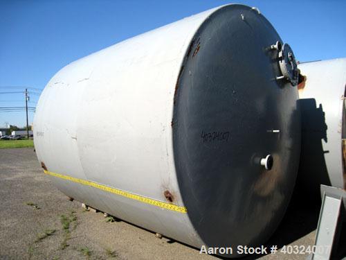 Used Tank, 8500 gallon, carbon steel,  vertical. Approximately 11' diameter x 12' straight side, dished top, flat bottom. Top manway, 4" NPT end bottom outlet.
