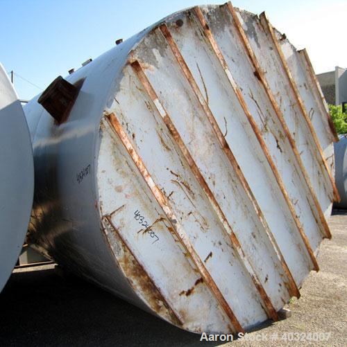 Used Tank, 8500 gallon, carbon steel,  vertical. Approximately 11' diameter x 12' straight side, dished top, flat bottom. Top manway, 4" NPT end bottom outlet.