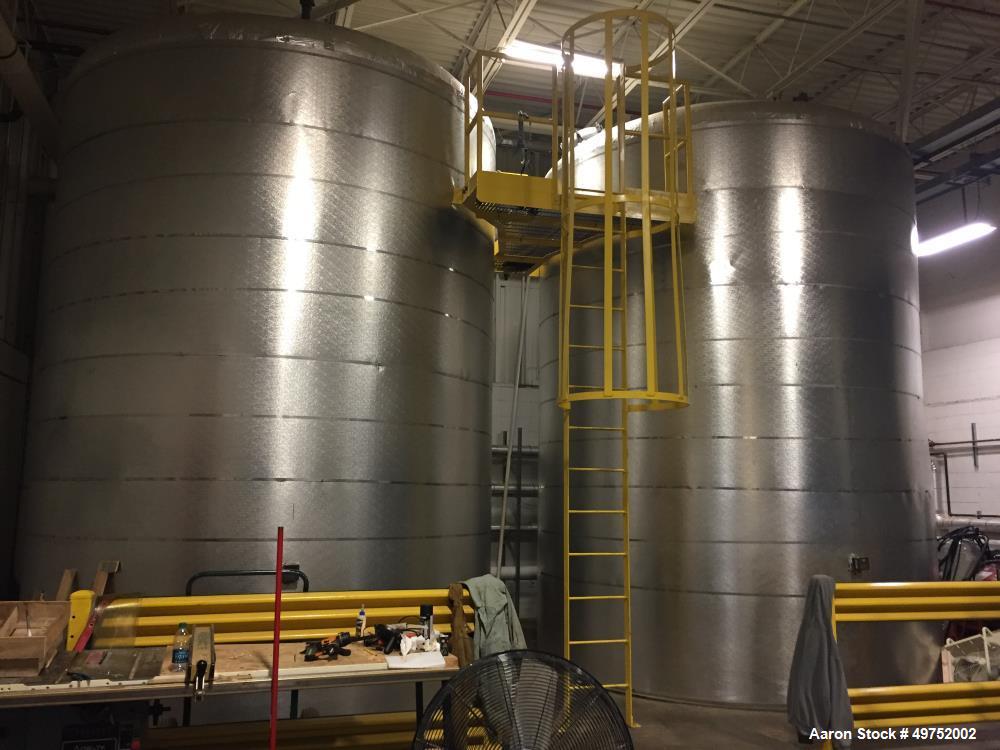 Used- 10,000 Gallon Carbon Steel Tank. 12' diameter x 15' high. Internal water heat coil and insulated.