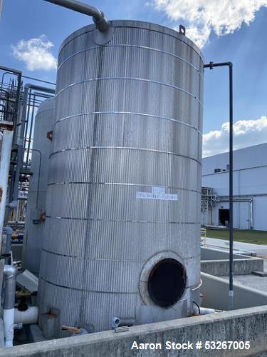 Used- approximately 9000 gallon carbon steel vertical storage tank.