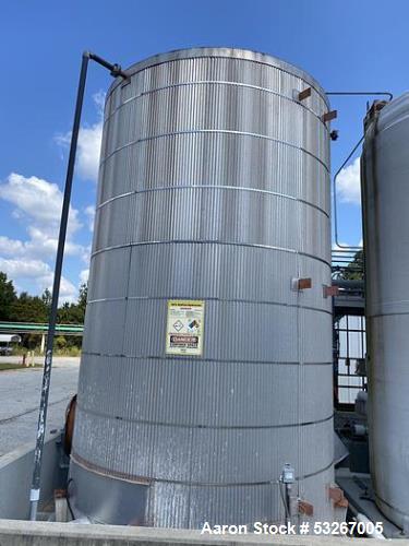 Used approximately 9000 gallon carbon steel vertical storage tank.