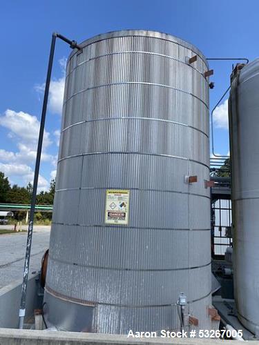 Used- approximately 9000 gallon carbon steel vertical storage tank.