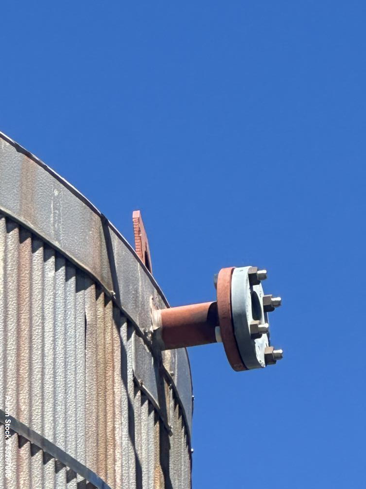 Used approximately 9000 gallon carbon steel vertical storage tank.