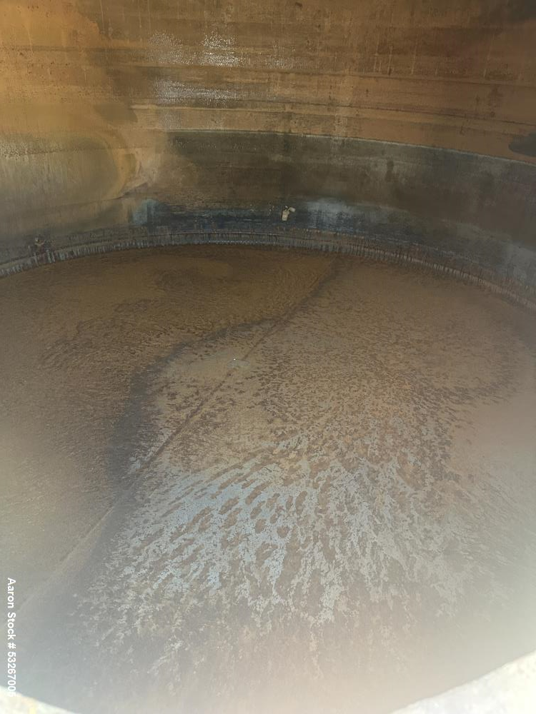 Used approximately 9000 gallon carbon steel vertical storage tank.