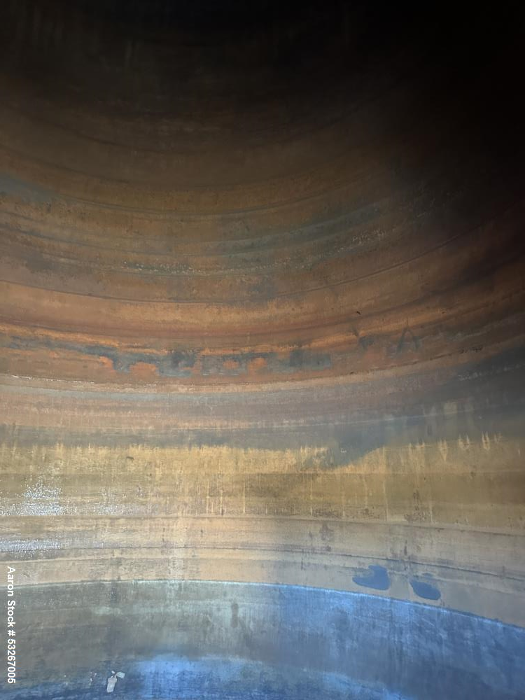 Used approximately 9000 gallon carbon steel vertical storage tank.