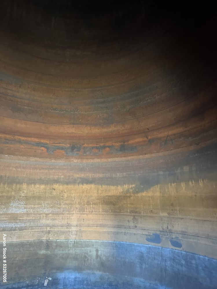 Used- approximately 9000 gallon carbon steel vertical storage tank.