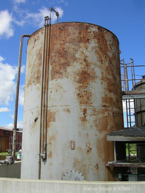 USED: Tank, 10,300 gallon, carbon steel, vertical. 10'6" diameter x 16' straight side. Slight coned top, flat bottom. Side bottom Lightnin agitator, model SG200,1 1/2" diameter x 18" long carbon stee...