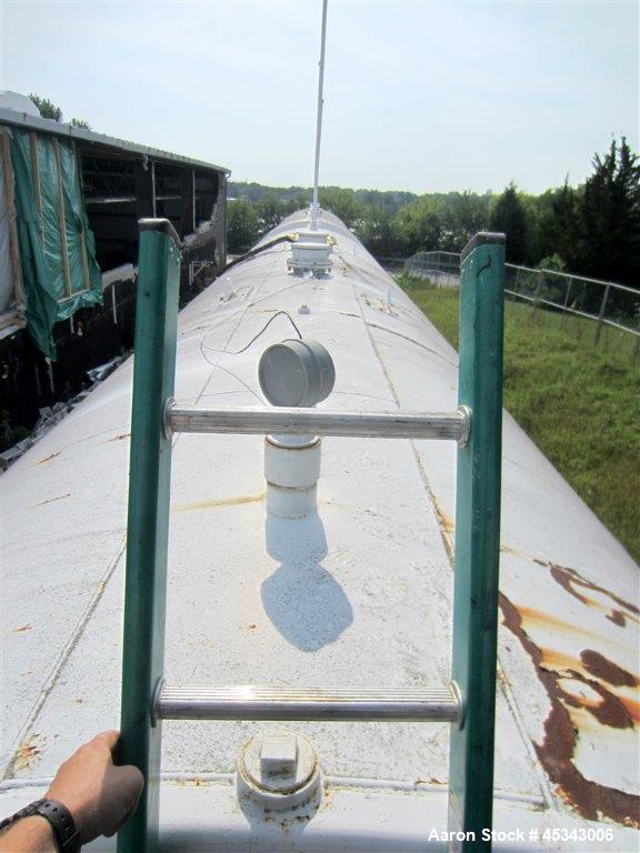 Used International Production Specialists Tank, Approximately 30,000 Gallons. Double wall, carbon steel, horizontal, flat heads.  12' Diameter x 490" straight side.  Various top openings.  Mounted on...