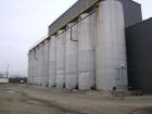 Used Approximate 30,000 Gallon Carbon Steel Storage Tank. Vertical, approximately 12' diameter x 32' high. Flat top and flat bottom. Insulated. Side bottom and top manways. Last used to store animal ...