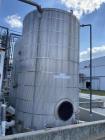 Used- approximately 9000 gallon carbon steel vertical storage tank.