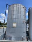 Used- approximately 9000 gallon carbon steel vertical storage tank.