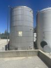 Used- approximately 9000 gallon carbon steel vertical storage tank.