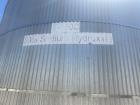 Used approximately 9000 gallon carbon steel vertical storage tank.
