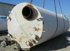 USED: Clawson tank, 9,000 gallon, carbon steel. Approximately 8' diameter x 24' straight side. Slight coned top, flat bottom. Internal rated atmos at 70 deg F. Openings: top 2