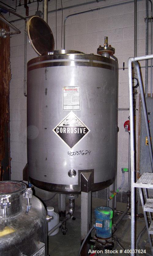 Used Tank, 325 gallon, stainless steel, vertical. 42" diameter x 50" straight side, flat top, dished bottom. Openings top 1",2",3",18" manway. 2" center bottom outlet. Mounted on 4 stainless steel le...