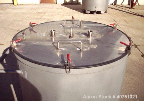 Unused-157 gallon type 304L stainless steel tank. 36" inside diameter x 36" deep. Open top with cover. Flat bottom. On casters. Forklift capable.
