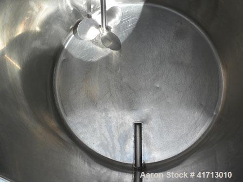 Used Tank, Approximate 140 Gallon, 316 Stainless Steel, Vertical.  34" diameter  x 36" straight side, flat top with hinged cover, sloped bottom.  Includes a clamp on agitator with a 1" diameter shaft...