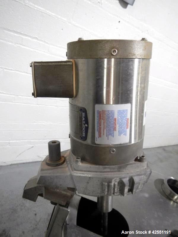 Used Bush Tank, 60 gallon, stainless steel construction, approximately 24" diameter x 32" straight side, open top with hinged cover, flat slopping bottom, 1" bottom outlet, clamp on .5 hp, 230/460 vo...