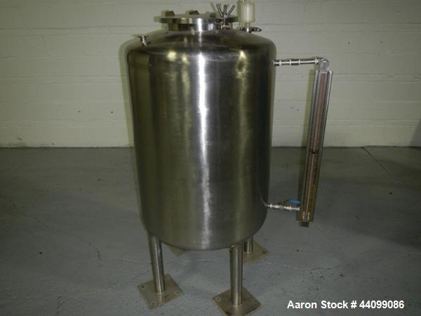 Used Tank, 75 gallon stainless steel, approximately 28" diameter x 30" straight side, dish top and bottom, 12" hand hole, 1.5", 1" top nozzles, 1" center bottom outlet on legs with 12" discharge heig...