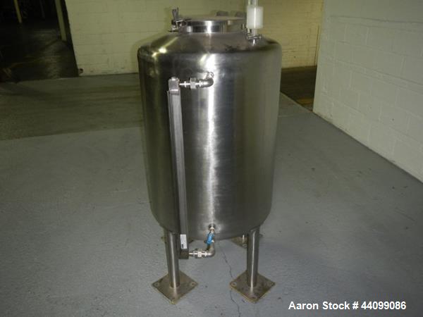 Used Tank, 75 gallon stainless steel, approximately 28" diameter x 30" straight side, dish top and bottom, 12" hand hole, 1.5", 1" top nozzles, 1" center bottom outlet on legs with 12" discharge heig...