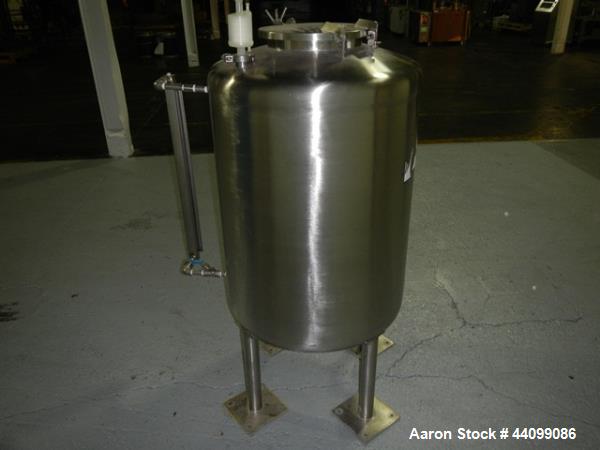Used Tank, 75 gallon stainless steel, approximately 28" diameter x 30" straight side, dish top and bottom, 12" hand hole, 1.5", 1" top nozzles, 1" center bottom outlet on legs with 12" discharge heig...