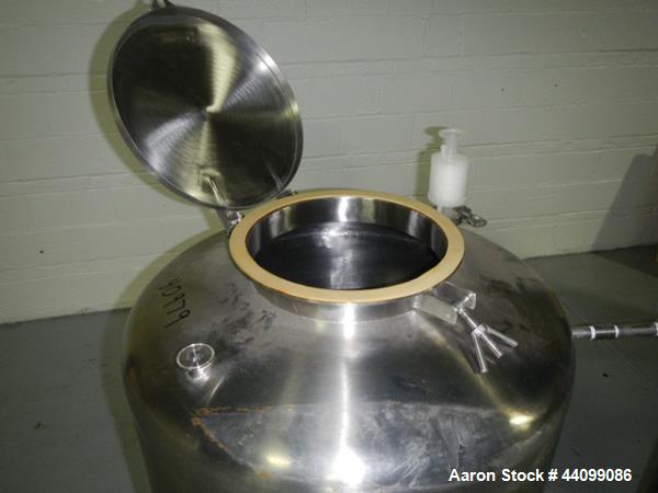 Used Tank, 75 gallon stainless steel, approximately 28" diameter x 30" straight side, dish top and bottom, 12" hand hole, 1.5", 1" top nozzles, 1" center bottom outlet on legs with 12" discharge heig...